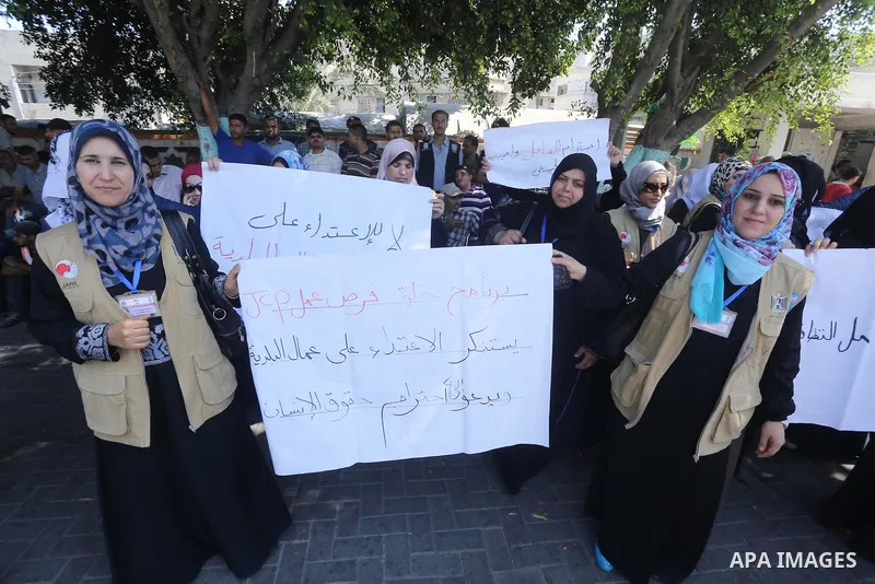 Palestinian employees of the Municipality take part in a protest against the attack on their colleague, in Gaza city, on August 29, 2015. Photo by Mohammed Asad