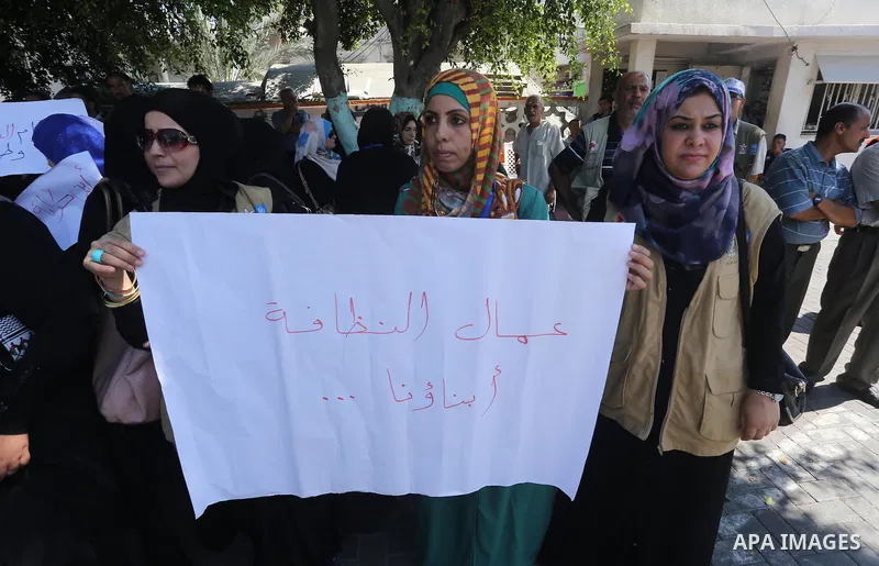 Palestinian employees of the Municipality take part in a protest against the attack on their colleague, in Gaza city, on August 29, 2015. Photo by Mohammed Asad