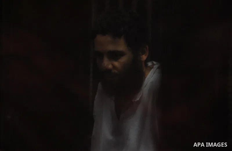 Egyptian suspects in the case of Suez terrorist group sit behind bars during during their trial, at a court, in Cairo, Egypt on August 29, 2015. Photo by Amr Sayed