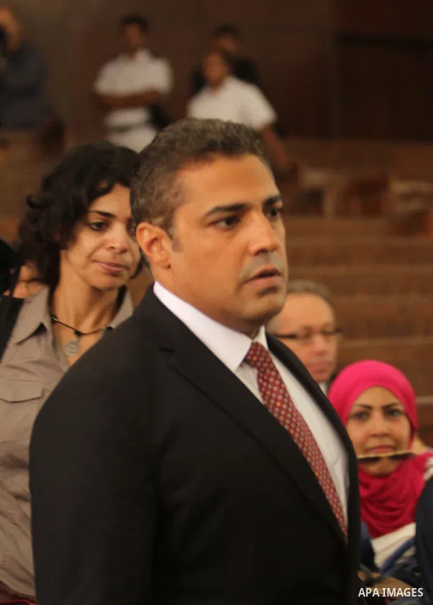 Al Jazeera television journalist Mohamed Fahmy walks to the dock before hearing the verdict at a court in Cairo, Egypt, August 29, 2015. An Egyptian court sentenced three Al Jazeera TV journalists to three years in priso...