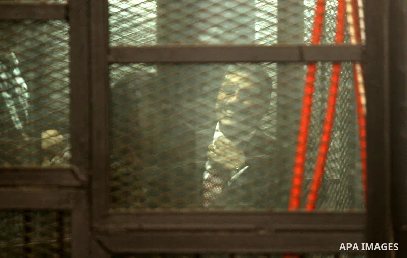 Al Jazeera television journalists Mohamed Fahmy and Baher Mohamed are seen behind bars before hearing the verdict at a court in Cairo, Egypt, August 29, 2015. An Egyptian court sentenced three Al Jazeera TV journalists t...