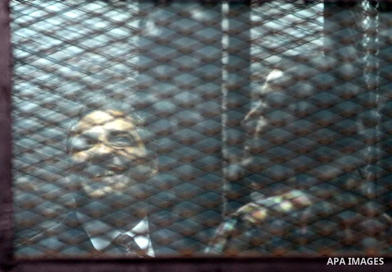 Al Jazeera television journalists Mohamed Fahmy and Baher Mohamed are seen behind bars before hearing the verdict at a court in Cairo, Egypt, August 29, 2015. An Egyptian court sentenced three Al Jazeera TV journalists t...
