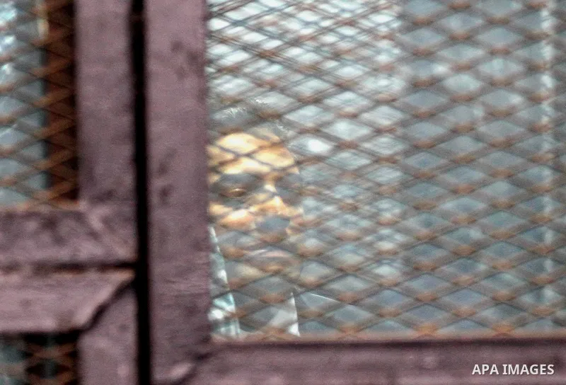 Al Jazeera television journalists Mohamed Fahmy and Baher Mohamed are seen behind bars before hearing the verdict at a court in Cairo, Egypt, August 29, 2015. An Egyptian court sentenced three Al Jazeera TV journalists t...