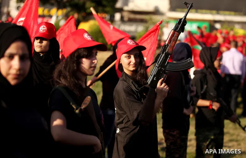 Palestinian girls participate in a military graduation ceremony of the Popular Front for the Liberation of Palestine (PFLP), in Gaza city on August 29, 2015. Photo by Ashraf Amra
