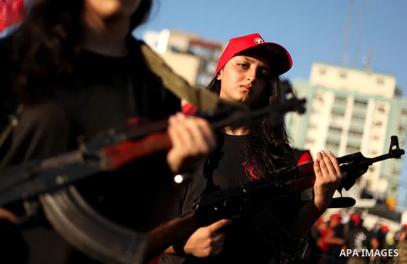 Palestinian girls participate in a military graduation ceremony of the Popular Front for the Liberation of Palestine (PFLP), in Gaza city on August 29, 2015. Photo by Ashraf Amra