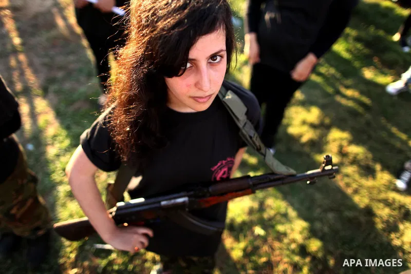 Palestinian girls participate in a military graduation ceremony of the Popular Front for the Liberation of Palestine (PFLP), in Gaza city on August 29, 2015. Photo by Ashraf Amra