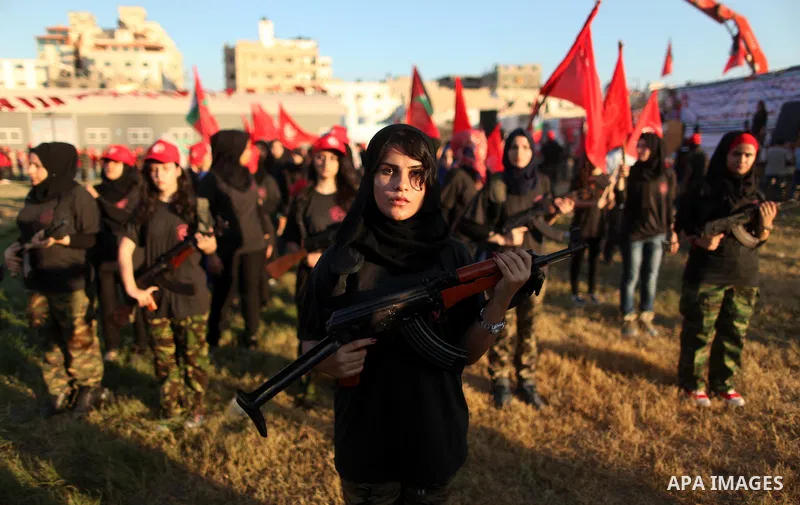 Palestinian girls participate in a military graduation ceremony of the Popular Front for the Liberation of Palestine (PFLP), in Gaza city on August 29, 2015. Photo by Ashraf Amra
