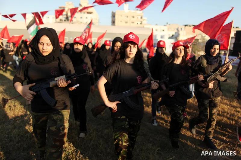 Palestinian girls participate in a military graduation ceremony of the Popular Front for the Liberation of Palestine (PFLP), in Gaza city on August 29, 2015. Photo by Ashraf Amra
