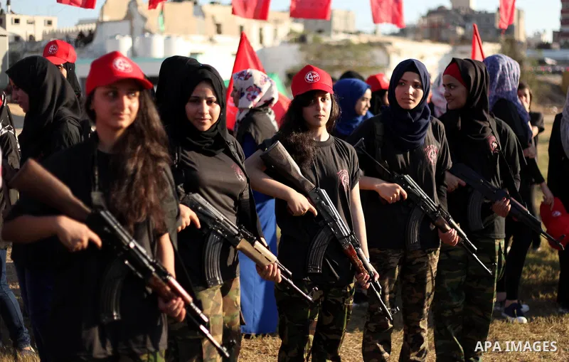 Palestinian girls participate in a military graduation ceremony of the Popular Front for the Liberation of Palestine (PFLP), in Gaza city on August 29, 2015. Photo by Ashraf Amra