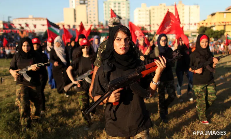 Palestinian girls participate in a military graduation ceremony of the Popular Front for the Liberation of Palestine (PFLP), in Gaza city on August 29, 2015. Photo by Ashraf Amra