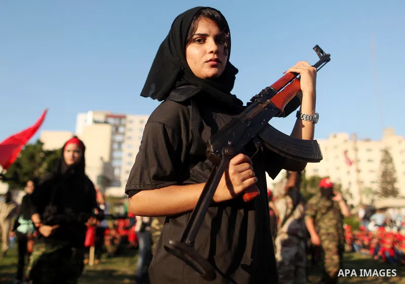 Palestinian girls participate in a military graduation ceremony of the Popular Front for the Liberation of Palestine (PFLP), in Gaza city on August 29, 2015. Photo by Ashraf Amra