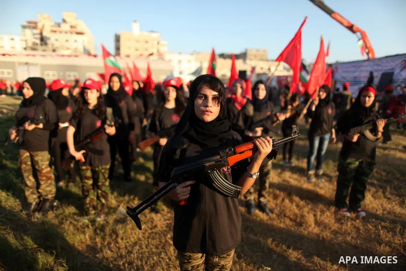 Palestinian girls participate in a military graduation ceremony of the Popular Front for the Liberation of Palestine (PFLP), in Gaza city on August 29, 2015. Photo by Ashraf Amra
