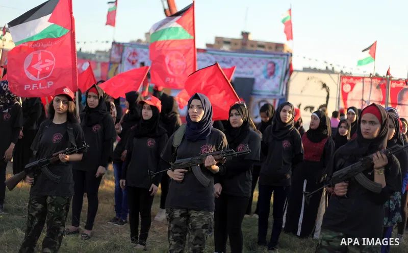 Palestinian girls participate in a military graduation ceremony of the Popular Front for the Liberation of Palestine (PFLP), in Gaza city on August 29, 2015. Photo by Ashraf Amra