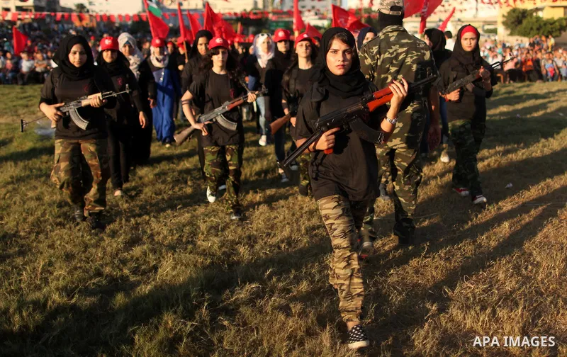 Palestinian girls participate in a military graduation ceremony of the Popular Front for the Liberation of Palestine (PFLP), in Gaza city on August 29, 2015. Photo by Ashraf Amra