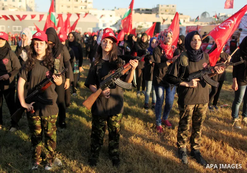 Palestinian girls participate in a military graduation ceremony of the Popular Front for the Liberation of Palestine (PFLP), in Gaza city on August 29, 2015. Photo by Ashraf Amra