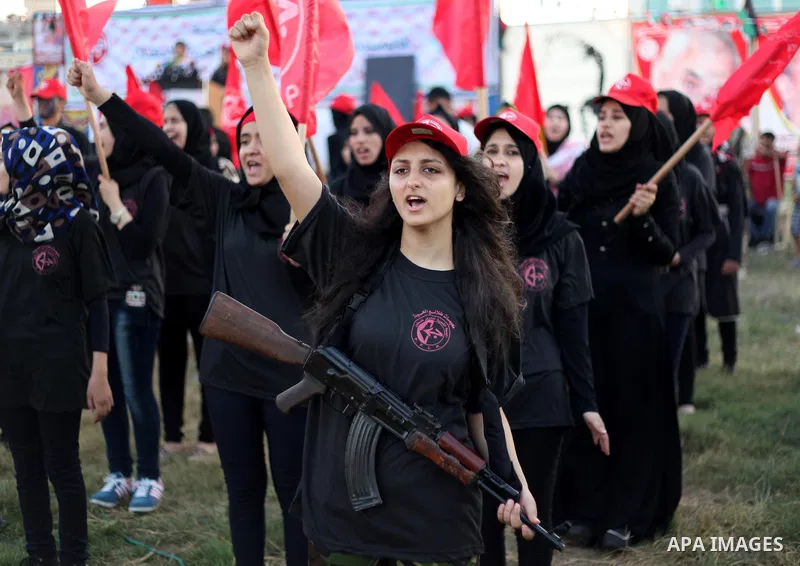 Palestinian girls participate in a military graduation ceremony of the Popular Front for the Liberation of Palestine (PFLP), in Gaza city on August 29, 2015. Photo by Ashraf Amra