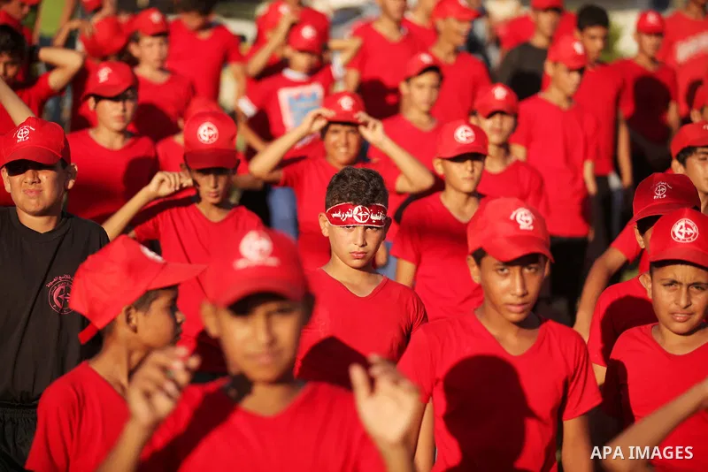Palestinian youths participate in a military graduation ceremony of the Popular Front for the Liberation of Palestine (PFLP), in Gaza city on August 29, 2015. Photo by Ashraf Amra