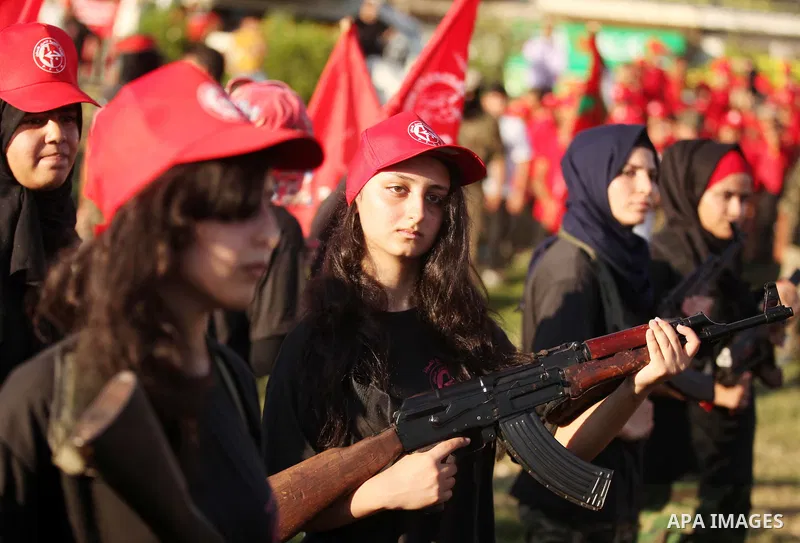 Palestinian girls participate in a military graduation ceremony of the Popular Front for the Liberation of Palestine (PFLP), in Gaza city on August 29, 2015. Photo by Ashraf Amra