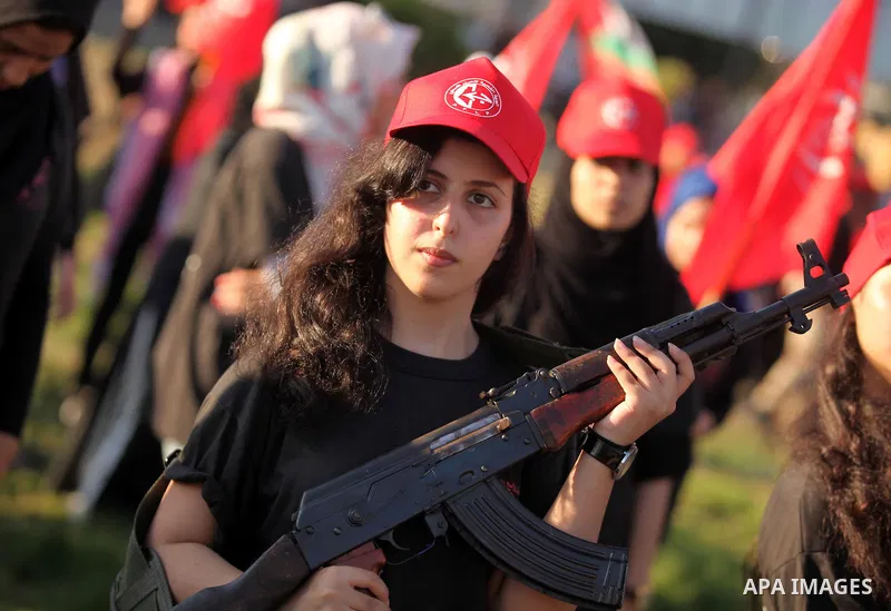 Palestinian girls participate in a military graduation ceremony of the Popular Front for the Liberation of Palestine (PFLP), in Gaza city on August 29, 2015. Photo by Ashraf Amra