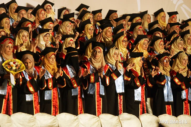 Palestinian students take part in their graduation ceremony at Al-Aqsa University in Khan Younis in the southern of Gaza strip on August 29, 2015. Photo by Abed Rahim Khatib
