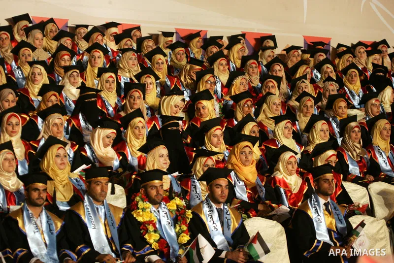 Palestinian students take part in their graduation ceremony at Al-Aqsa University in Khan Younis in the southern of Gaza strip on August 29, 2015. Photo by Abed Rahim Khatib