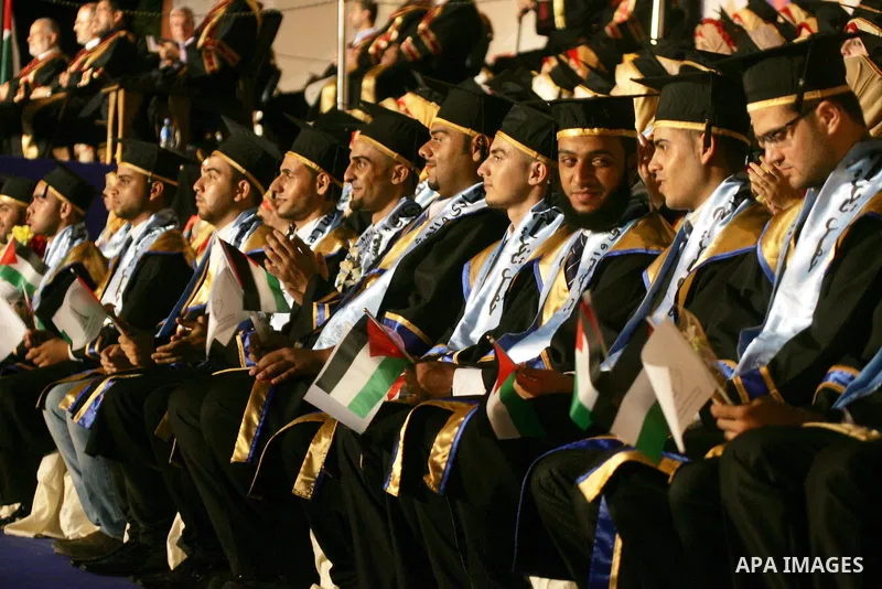 Palestinian students take part in their graduation ceremony at Al-Aqsa University in Khan Younis in the southern of Gaza strip on August 29, 2015. Photo by Abed Rahim Khatib
