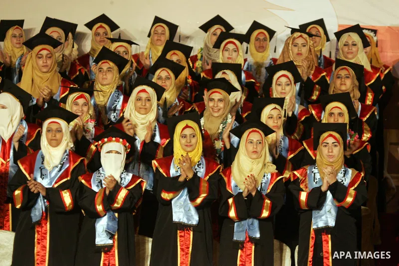 Palestinian students take part in their graduation ceremony at Al-Aqsa University in Khan Younis in the southern of Gaza strip on August 29, 2015. Photo by Abed Rahim Khatib