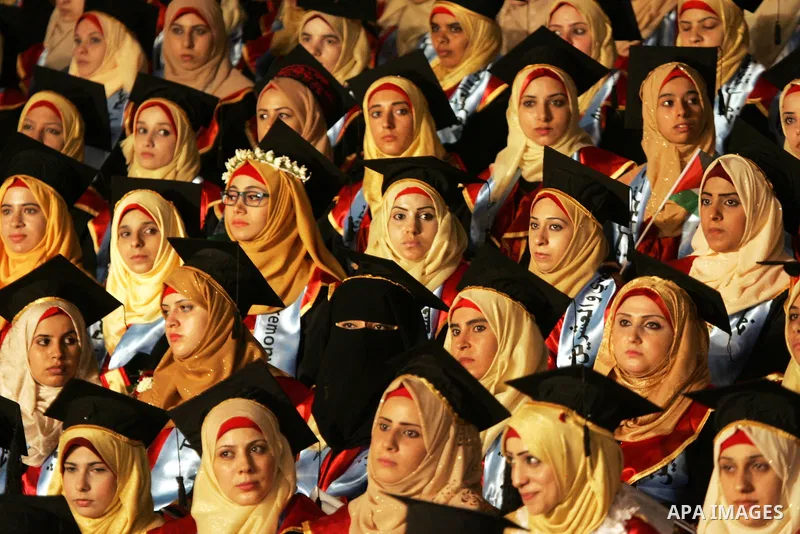 Palestinian students take part in their graduation ceremony at Al-Aqsa University in Khan Younis in the southern of Gaza strip on August 29, 2015. Photo by Abed Rahim Khatib