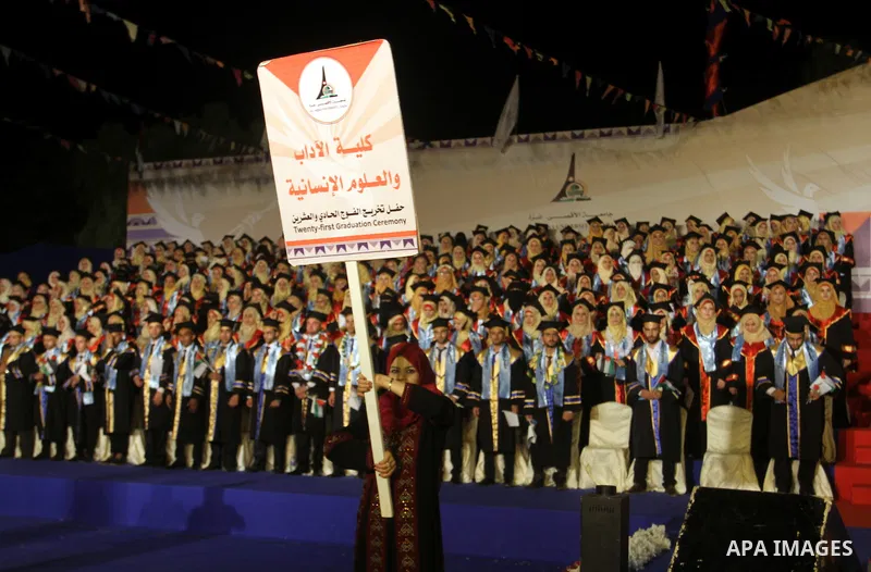 Palestinian students take part in their graduation ceremony at Al-Aqsa University in Khan Younis in the southern of Gaza strip on August 29, 2015. Photo by Abed Rahim Khatib