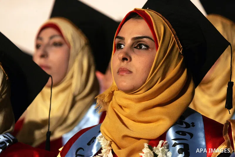 Palestinian students take part in their graduation ceremony at Al-Aqsa University in Khan Younis in the southern of Gaza strip on August 29, 2015. Photo by Abed Rahim Khatib