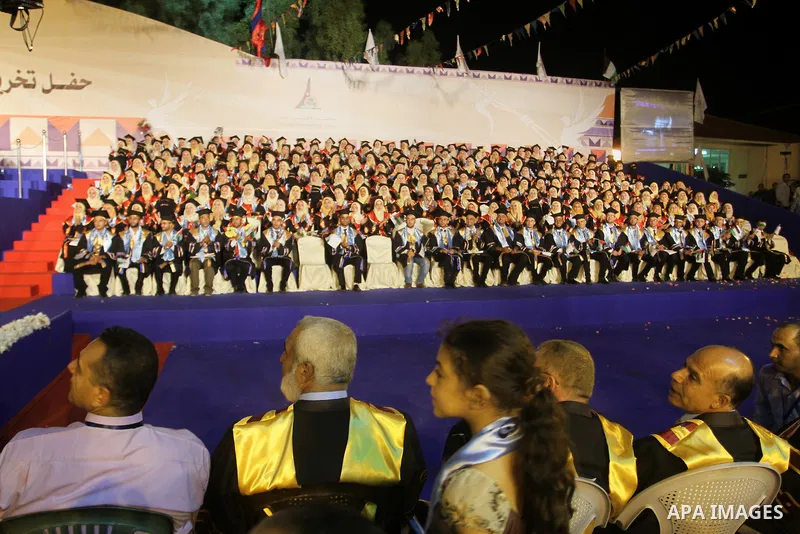 Palestinian students take part in their graduation ceremony at Al-Aqsa University in Khan Younis in the southern of Gaza strip on August 29, 2015. Photo by Abed Rahim Khatib