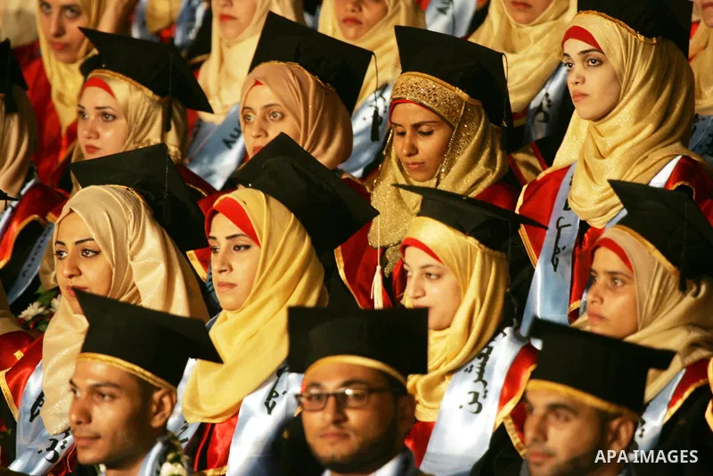 Palestinian students take part in their graduation ceremony at Al-Aqsa University in Khan Younis in the southern of Gaza strip on August 29, 2015. Photo by Abed Rahim Khatib