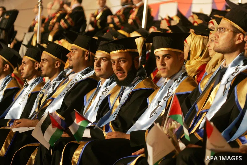 Palestinian students take part in their graduation ceremony at Al-Aqsa University in Khan Younis in the southern of Gaza strip on August 29, 2015. Photo by Abed Rahim Khatib