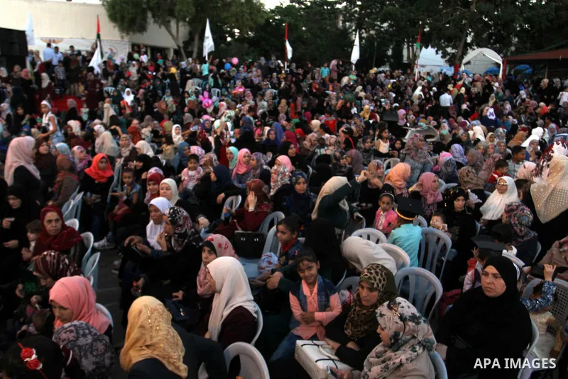 Palestinian students take part in their graduation ceremony at Al-Aqsa University in Khan Younis in the southern of Gaza strip on August 29, 2015. Photo by Abed Rahim Khatib