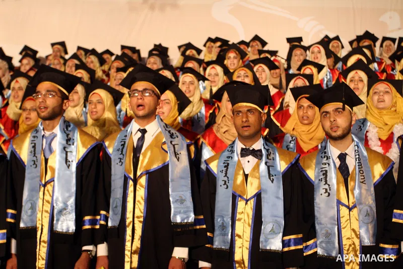 Palestinian students take part in their graduation ceremony at Al-Aqsa University in Khan Younis in the southern of Gaza strip on August 29, 2015. Photo by Abed Rahim Khatib