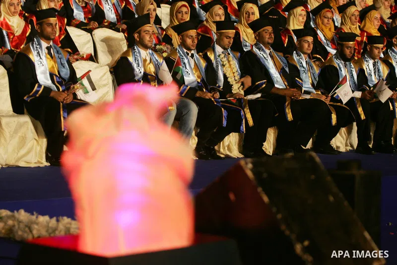 Palestinian students take part in their graduation ceremony at Al-Aqsa University in Khan Younis in the southern of Gaza strip on August 29, 2015. Photo by Abed Rahim Khatib