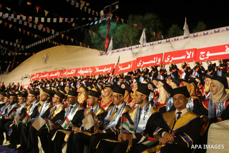 Palestinian students take part in their graduation ceremony at Al-Aqsa University in Khan Younis in the southern of Gaza strip on August 29, 2015. Photo by Abed Rahim Khatib