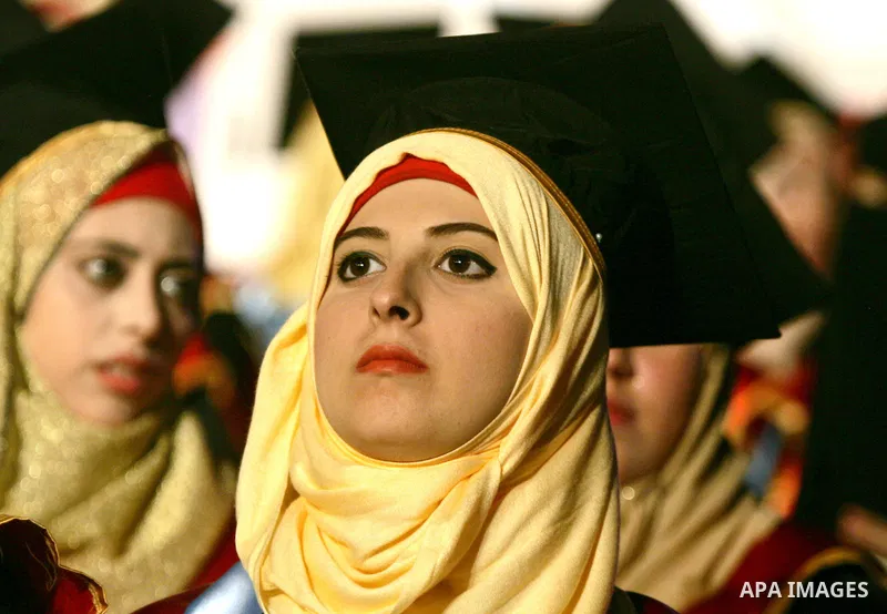 Palestinian students take part in their graduation ceremony at Al-Aqsa University in Khan Younis in the southern of Gaza strip on August 29, 2015. Photo by Abed Rahim Khatib