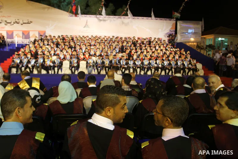 Palestinian students take part in their graduation ceremony at Al-Aqsa University in Khan Younis in the southern of Gaza strip on August 29, 2015. Photo by Abed Rahim Khatib