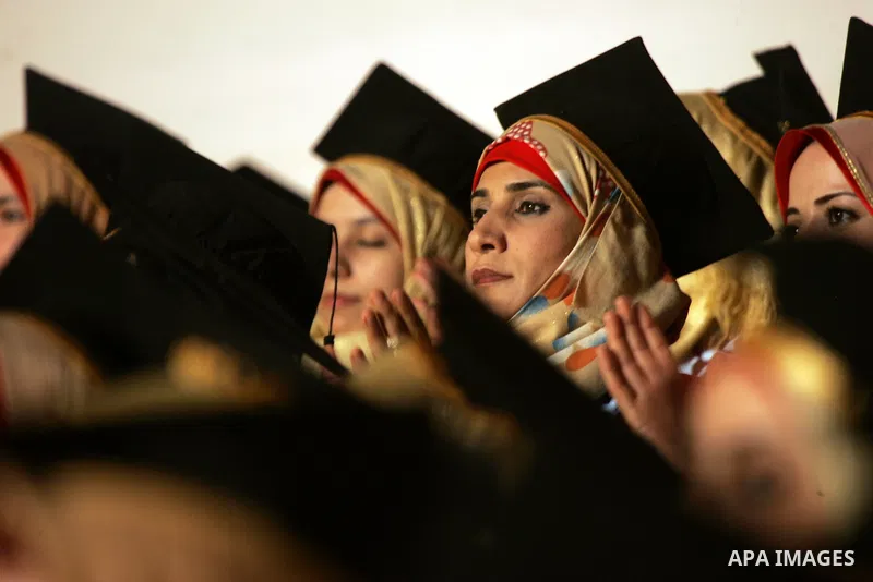 Palestinian students take part in their graduation ceremony at Al-Aqsa University in Khan Younis in the southern of Gaza strip on August 29, 2015. Photo by Abed Rahim Khatib