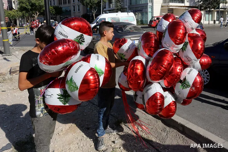 People carry Lebanese national flags and chant slogans as they take part in an anti-government protest at Martyrs' Square in downtown Beirut, Lebanon August 29, 2015. Thousands of protesters waving Lebanese flags and cha...