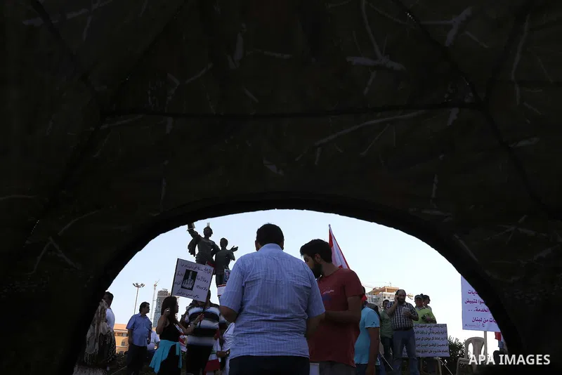People carry Lebanese national flags and chant slogans as they take part in an anti-government protest at Martyrs' Square in downtown Beirut, Lebanon August 29, 2015. Thousands of protesters waving Lebanese flags and cha...