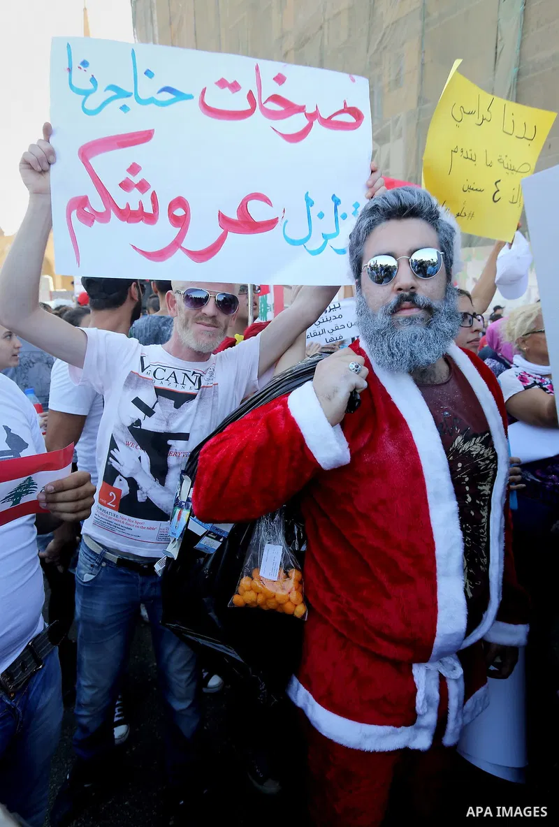 People carry Lebanese national flags and chant slogans as they take part in an anti-government protest at Martyrs' Square in downtown Beirut, Lebanon August 29, 2015. Thousands of protesters waving Lebanese flags and cha...
