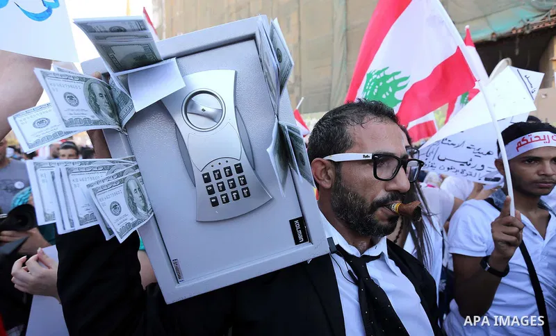 People carry Lebanese national flags and chant slogans as they take part in an anti-government protest at Martyrs' Square in downtown Beirut, Lebanon August 29, 2015. Thousands of protesters waving Lebanese flags and cha...