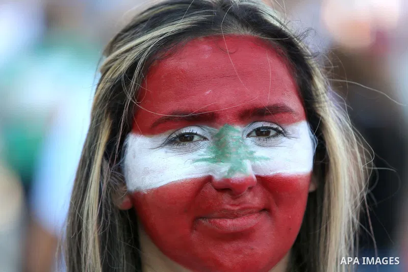 People carry Lebanese national flags and chant slogans as they take part in an anti-government protest at Martyrs' Square in downtown Beirut, Lebanon August 29, 2015. Thousands of protesters waving Lebanese flags and cha...
