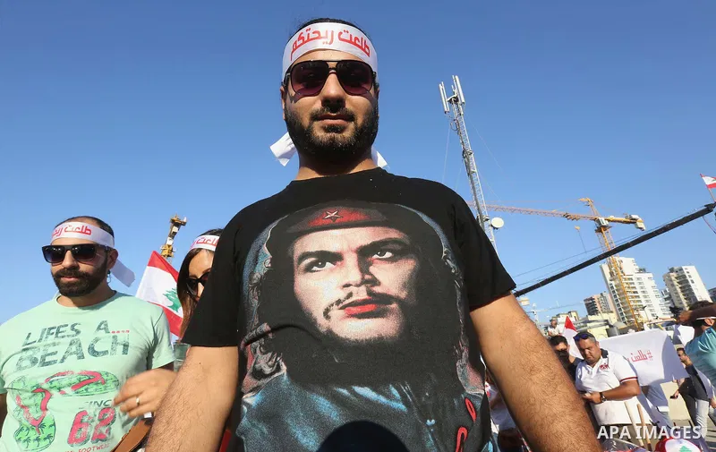 People carry Lebanese national flags and chant slogans as they take part in an anti-government protest at Martyrs' Square in downtown Beirut, Lebanon August 29, 2015. Thousands of protesters waving Lebanese flags and cha...