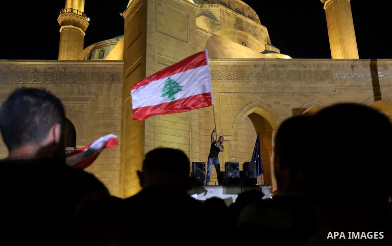 People carry Lebanese national flags and chant slogans as they take part in an anti-government protest at Martyrs' Square in downtown Beirut, Lebanon August 29, 2015. Thousands of protesters waving Lebanese flags and cha...