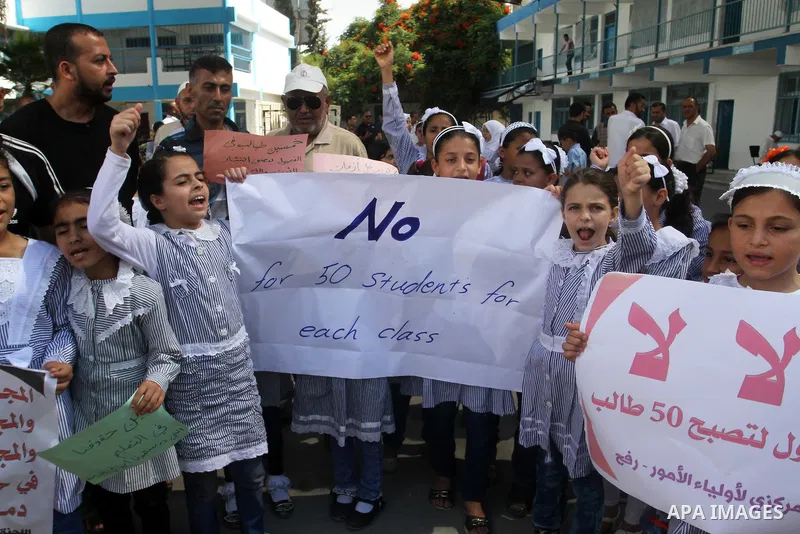 Palestinian pupils take part in a protest against the reduction of educational programs given by the United Nations Relief and Works Agency (UNRWA) and the growing number of students per class due to lack of funds in the...