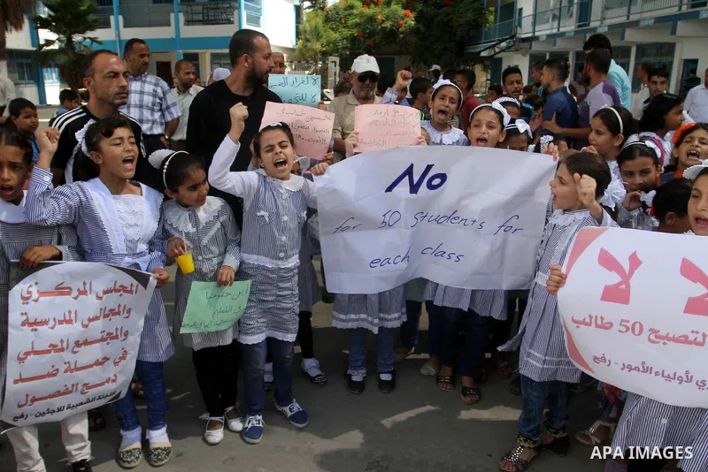 Palestinian pupils take part in a protest against the reduction of educational programs given by the United Nations Relief and Works Agency (UNRWA) and the growing number of students per class due to lack of funds in the...