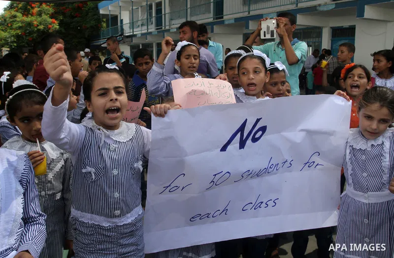 Palestinian pupils take part in a protest against the reduction of educational programs given by the United Nations Relief and Works Agency (UNRWA) and the growing number of students per class due to lack of funds in the...